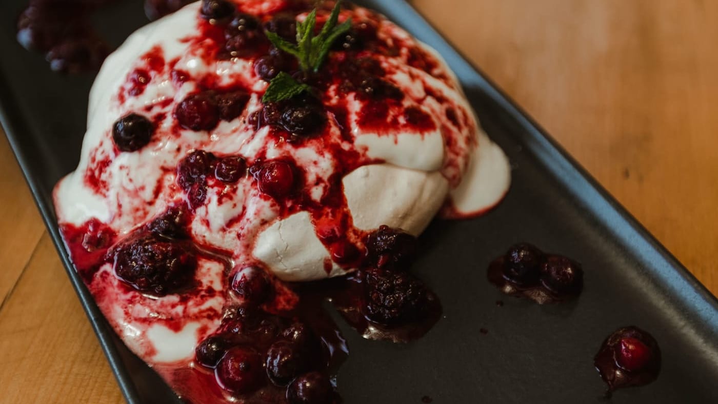 A cream dessert with berry coulis