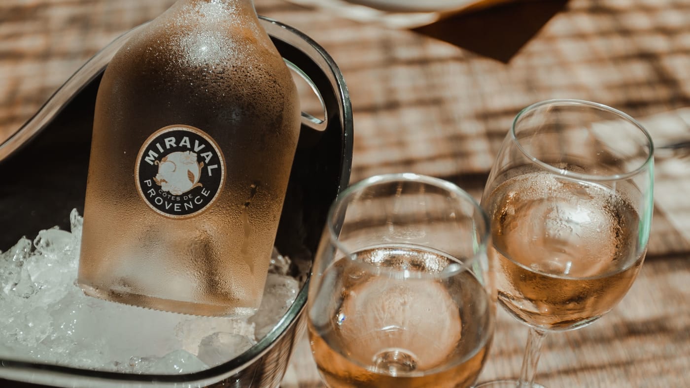 A bottle of chilled rosé with glasses