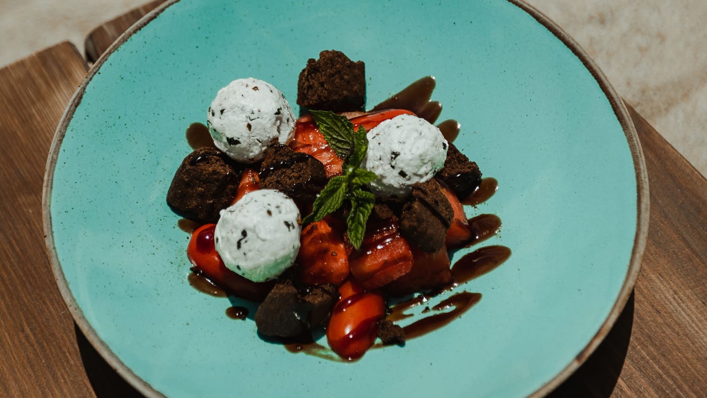 Fresh watermelon salad with mint cheese cream on a turquoise plate