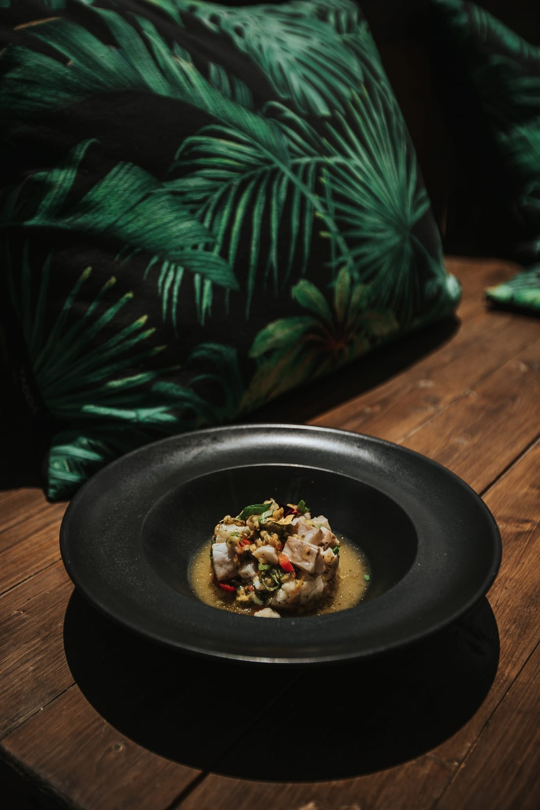 Sea bass ceviche in a black bowl